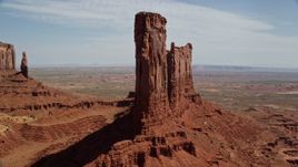 5.5K aerial stock footage of orbiting buttes surrounded by a desert valley, Monument Valley, Utah, Arizona Aerial Stock Footage | AX135_048E