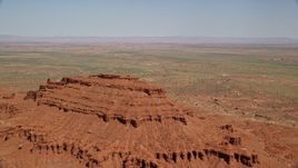 5.5K aerial stock footage of flying over butte while approaching desert valley, Monument Valley, Utah, Arizona Aerial Stock Footage | AX135_051