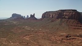 5.5K aerial stock footage approach Setting Hen Butte in Monument Valley, Utah, Arizona Aerial Stock Footage | AX135_056E