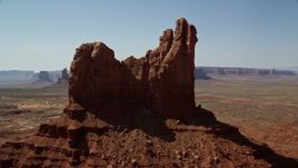 5.5K aerial stock footage of flying by buttes and mesas in desert valley, Monument Valley, Utah, Arizona Aerial Stock Footage | AX135_061