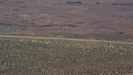 5.5K aerial stock footage of a car slowing to a stop on Highway 163, Monument Valley, Utah, Arizona Aerial Stock Footage | AX135_066E