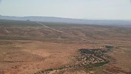 5.5K aerial stock footage of flying toward Highway 163 in desert valley, Monument Valley, Utah, Arizona Aerial Stock Footage | AX135_070E