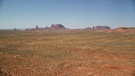 5.5K aerial stock footage of a wide view of distant buttes in an open desert valley, Monument Valley, Utah, Arizona Aerial Stock Footage | AX135_084