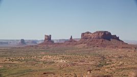 5.5K aerial stock footage of flying by buttes, with Highway 163 in the foreground, Monument Valley, Utah, Arizona Aerial Stock Footage | AX135_101E