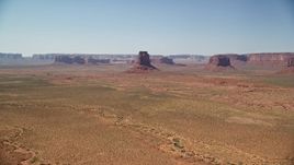5.5K aerial stock footage of an approach to East Mitten Butte in a desert valley, Monument Valley, Utah, Arizona Aerial Stock Footage | AX135_112E