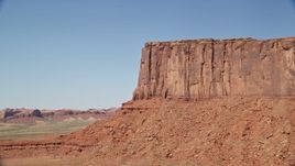 5.5K aerial stock footage of flying by cliffs of Meridian Butte, Monument Valley, Utah, Arizona Aerial Stock Footage | AX135_130