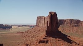 5.5K aerial stock footage of flying by the steep sides of Meridian Butte, Monument Valley, Utah, Arizona Aerial Stock Footage | AX135_139E