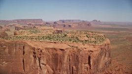 5.5K aerial stock footage of flying over Hunt's Mesa, approach wide desert valley, Monument Valley, Utah, Arizona Aerial Stock Footage | AX135_160E