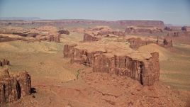 5.5K aerial stock footage of flying by a group of desert buttes and mesas, Monument Valley, Utah, Arizona Aerial Stock Footage | AX135_172E