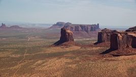5.5K aerial stock footage of passing by Gray Whiskers Butte, Monument Valley, Arizona, Utah Aerial Stock Footage | AX135_190E