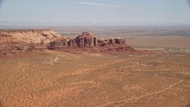 5.5K aerial stock footage of passing town of Goulding by Rock Door Mesa, Navajo Nation Reservation, Utah, Arizona Aerial Stock Footage | AX135_196E