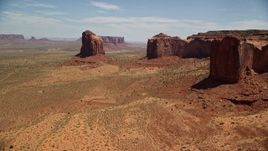 5.5K aerial stock footage of flying by Gray Whiskers Butte, Mitchell Mesa, Monument Valley, Utah, Arizona Aerial Stock Footage | AX136_011