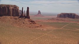 5.5K aerial stock footage of buttes in a desert valley, Monument Valley, Utah, Arizona Aerial Stock Footage | AX136_017E