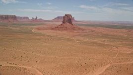 5.5K aerial stock footage tilt from desert valley to reveal East Mitten Butte, Monument Valley, Utah, Arizona Aerial Stock Footage | AX136_027