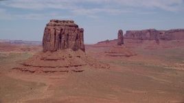 5.5K aerial stock footage of flying by Merrick Butte near West Mitten Butte, Monument Valley, Utah, Arizona Aerial Stock Footage | AX136_029