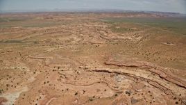 5.5K aerial stock footage of a wide view of open desert valley, north of Monument Valley, Utah, Arizona Aerial Stock Footage | AX136_046E