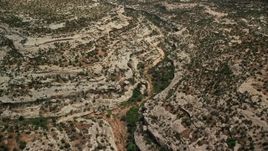 5.5K aerial stock footage of flying over desert canyon, Natural Bridges National Monument, Utah Aerial Stock Footage | AX136_124E