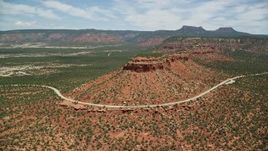 5.5K aerial stock footage of orbiting State Route 275 rounding a butte, Manti-La Sal National Forest, Utah Aerial Stock Footage | AX136_128E