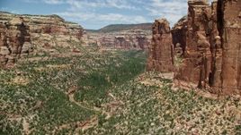 5.5K aerial stock footage of near tall rock formations in Arch Canyon, Utah Aerial Stock Footage | AX136_154
