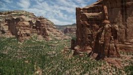 5.5K aerial stock footage of flying low over trees and vegetation in Arch Canyon, Utah Aerial Stock Footage | AX136_158E