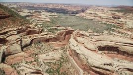 5.5K aerial stock footage of flying over box canyon, approaching green valley, Canyonlands National Park, Utah Aerial Stock Footage | AX136_202E