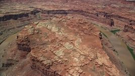 5.5K aerial stock footage of passing over the edge of a butte and the Colorado River in Meander Canyon, Canyonlands National Park, Utah Aerial Stock Footage | AX136_242E