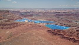 5.5K aerial stock footage of flying toward potash ponds in a desert valley, Moab, Utah Aerial Stock Footage | AX136_268E
