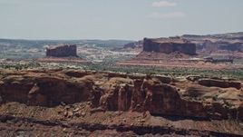 5.5K aerial stock footage of flying by Monitor Butte and Merrimac Butte, Moab, Utah Aerial Stock Footage | AX136_289