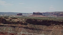 5.5K aerial stock footage of passing by Monitor Butte and Merrimac Butte, Moab, Utah Aerial Stock Footage | AX136_290