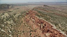 5.5K aerial stock footage tilt to bird's eye of desert cliffs in Eagle Park, Arches National Park, Utah Aerial Stock Footage | AX137_029E