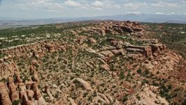 5.5K aerial stock footage of passing rock formations and desert vegetation, Eagle Park, Arches National Park, Utah Aerial Stock Footage | AX137_037E