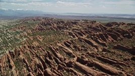 5.5K aerial stock footage of passing by Devil's Garden rock fins at Arches National Park, Utah Aerial Stock Footage | AX137_050