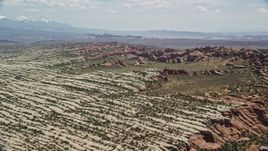 5.5K aerial stock footage of passing rock formations and desert plants in Devil's Garden, Arches National Park, Utah Aerial Stock Footage | AX137_052E