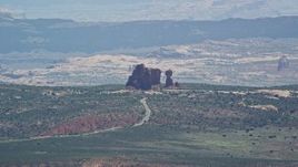 5.5K aerial stock footage of a view of Balanced Rock and Scenic Drive, Arches National Park, Utah Aerial Stock Footage | AX137_059E