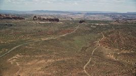 5.5K aerial stock footage of flying by Ham Rock and Balanced Rock near Arches Scenic Drive, Arches National Park, Utah Aerial Stock Footage | AX137_063E