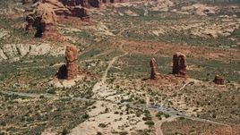 5.5K aerial stock footage of a close orbit of Balanced Rock and Arches Scenic Drive, Arches National Park, Utah Aerial Stock Footage | AX137_067E