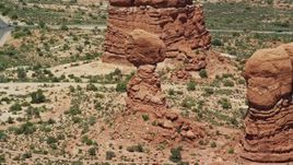 5.5K aerial stock footage of a Balanced Rock rock formation at Arches National Park, Utah Aerial Stock Footage | AX137_069