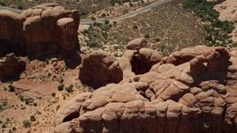5.5K aerial stock footage of a reverse view of Double Arch and Elephant Butte at Arches National Park, Utah Aerial Stock Footage | AX137_073