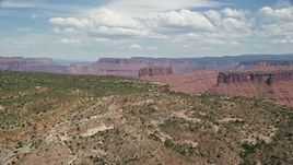 5.5K aerial stock footage of mesas and buttes seen from the top of Dry Mesa, Moab, Utah Aerial Stock Footage | AX137_082E