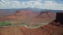 5.5K aerial stock footage of buttes and the Colorado River seen from the side of Dry Mesa, Moab, Utah Aerial Stock Footage | AX137_086E