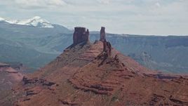 5.5K aerial stock footage of flying by two tall buttes in the desert, Moab, Utah Aerial Stock Footage | AX137_095E