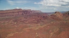 5.5K aerial stock footage approach Fisher Towers at base of mesa with rock formations, Utah Aerial Stock Footage | AX137_098E