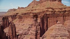 5.5K aerial stock footage fly away from The Titan and other rock formations at Fisher Towers, Utah Aerial Stock Footage | AX137_110E