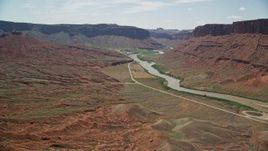 5.5K aerial stock footage of flying toward a large mesa by the Colorado River in Moab, Utah Aerial Stock Footage | AX137_150E