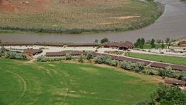 5.5K aerial stock footage of Red Cliffs Lodge hotel by the Colorado River in Moab, Utah Aerial Stock Footage | AX137_157