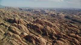 5.5K aerial stock footage of desert rock formations near shallow canyon, Moab, Utah Aerial Stock Footage | AX138_046E