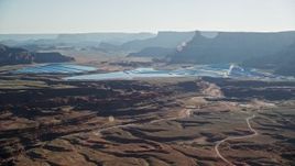 5.5K aerial stock footage of passing by industrial potash ponds in the desert, Moab, Utah Aerial Stock Footage | AX138_058