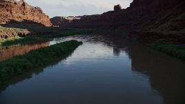 5.5K aerial stock footage follow the river through shaded part of Goose Neck, Meander Canyon, Canyonlands National Park, Utah Aerial Stock Footage | AX138_096E
