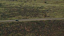 5.5K aerial stock footage track sedan on desert road through Canyonlands National Park, Utah Aerial Stock Footage | AX138_122E
