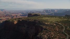 5.5K aerial stock footage approach and tilt to cars parked on Dead Horse Point Overlook with view of Canyonlands National Park, Utah Aerial Stock Footage | AX138_155E